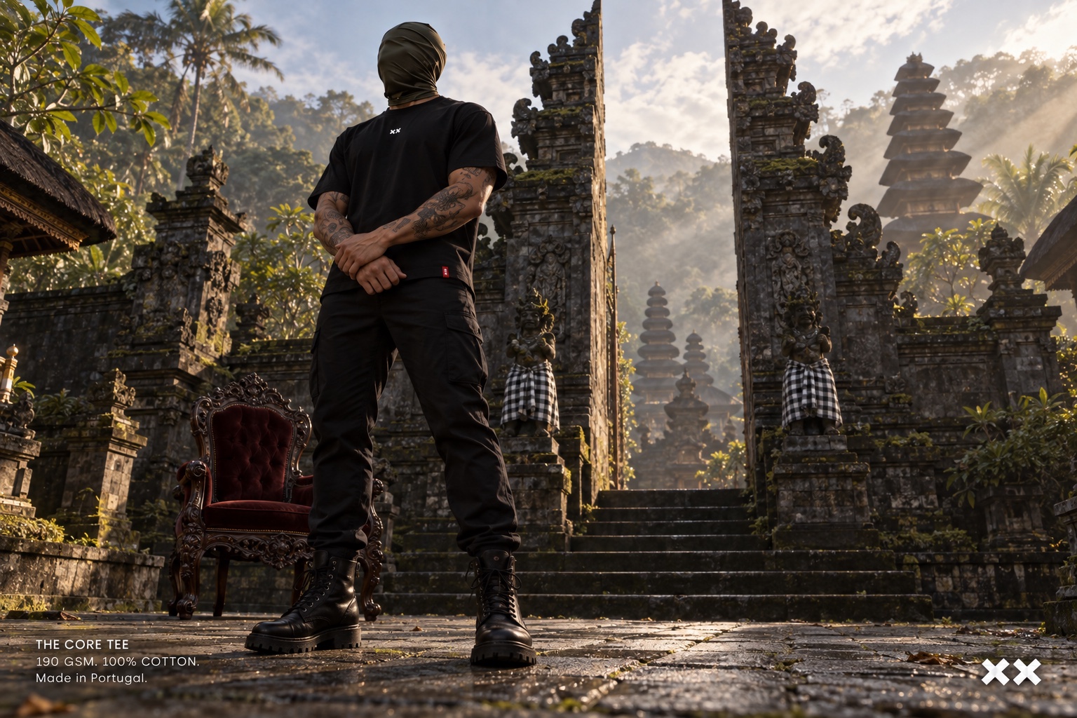 Black Core Tee worn with a full-face balaclava beside a red velvet chair on temple steps